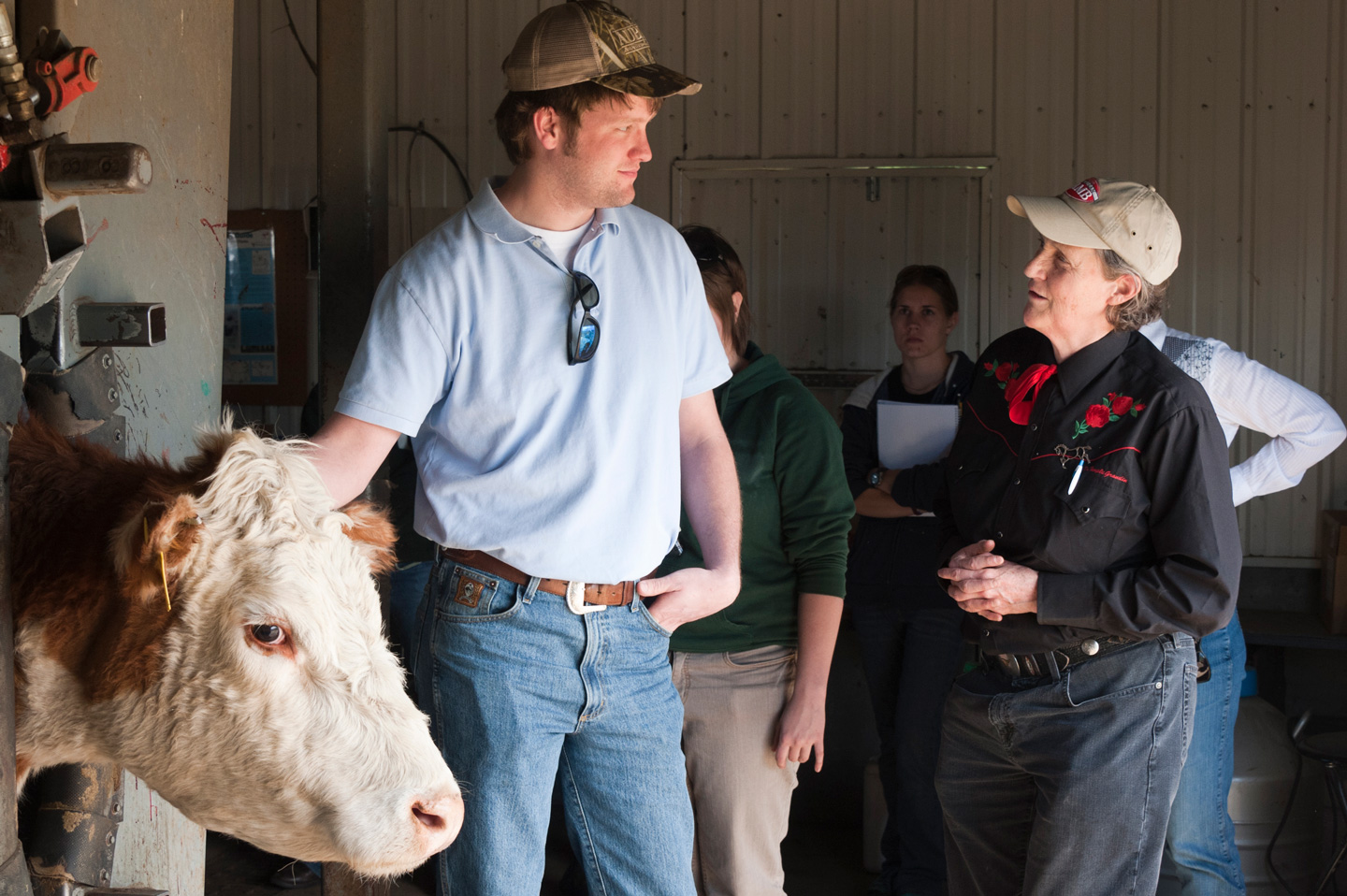 Temple Grandin having a conversation with a farmer.
