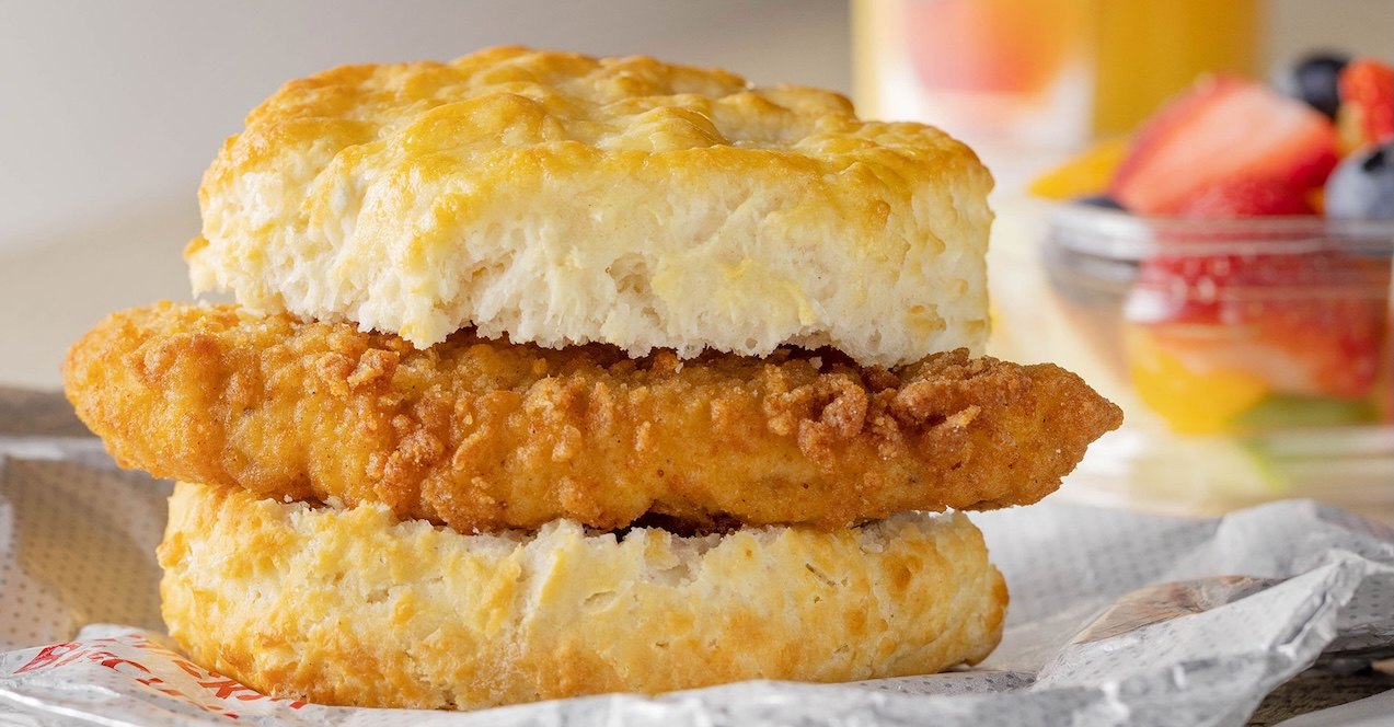 Chick-fil-A® Chicken Biscuit and a cup of mixed fruit.