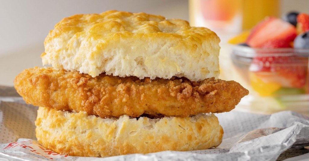 Chick-fil-A® Chicken Biscuit and a cup of mixed fruit.