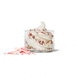 An Icedream® Dessert with Peppermint Bark Chips, in a glass dish with candy cane pieces.