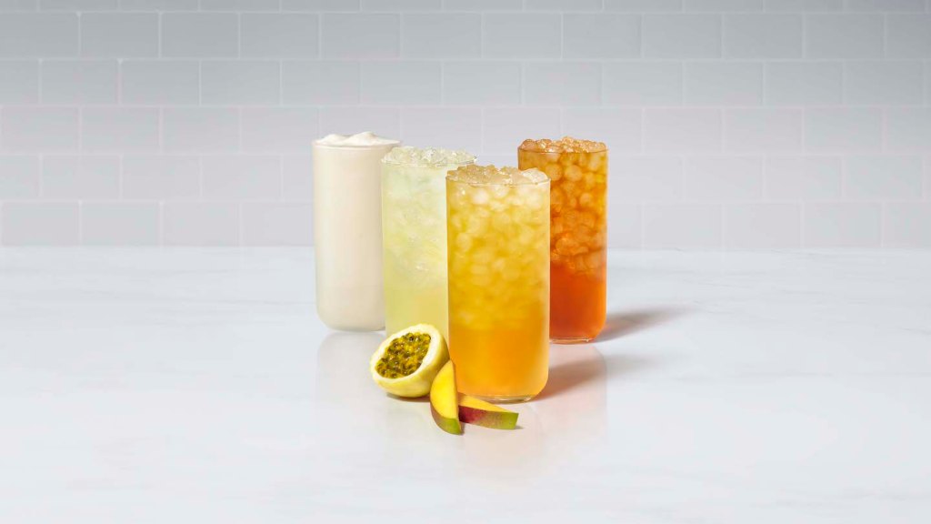 A glass of Mango Passion Sunjoy®, Mango Passion Lemonade, Mango Passion Tea and Mango Passion Frosted Lemonade, with fresh sliced mango and passion fruit.