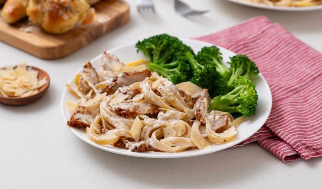 Plated Chicken Alfredo with a side of broccoli