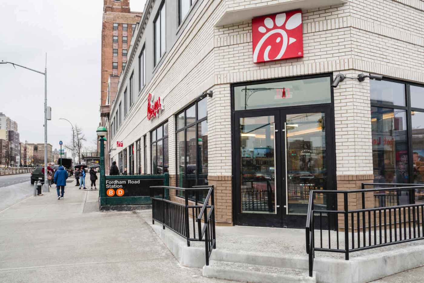 Chick-fil-A® restaurant and subway entrance on a city sidewalk.