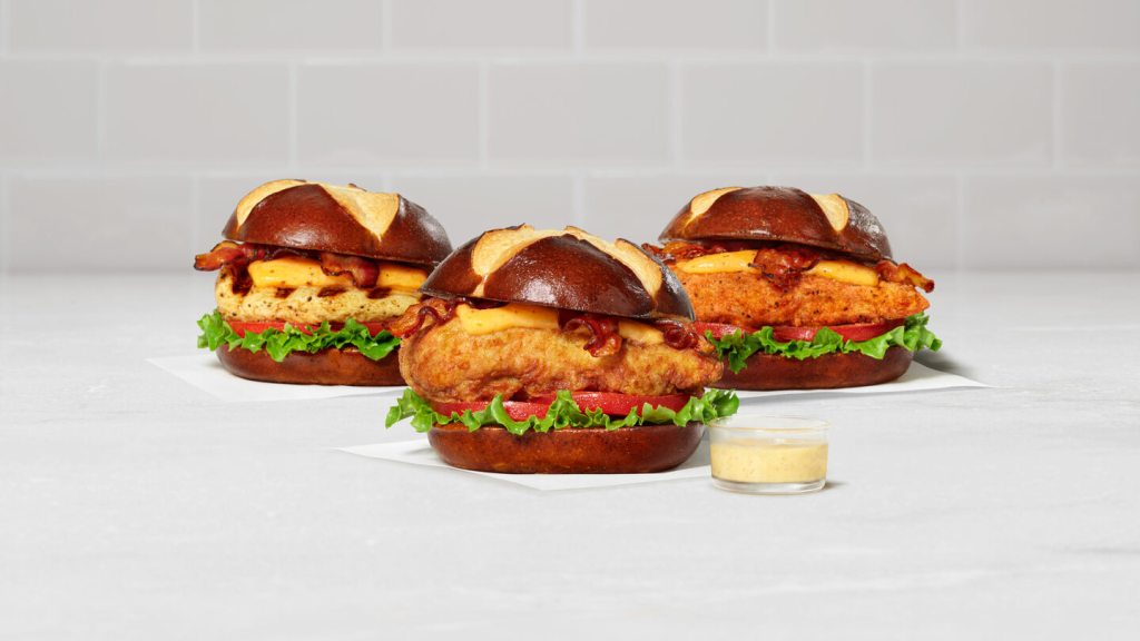 Three The Pretzel Cheddar Club Sandwiches; Grilled, Spicy and Original.