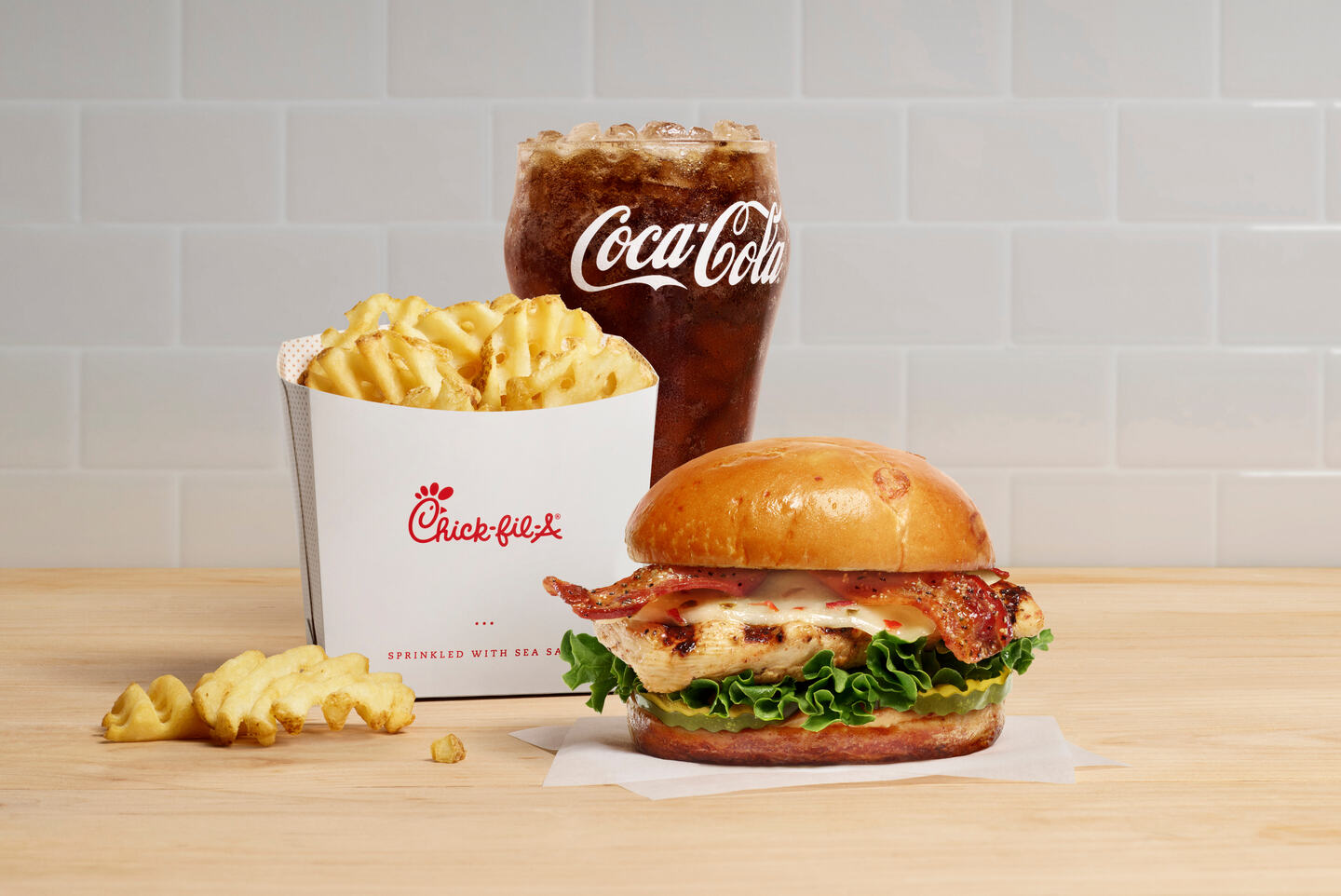 Maple Pepper Bacon Sandwich with waffle fries and a Coca Cola.