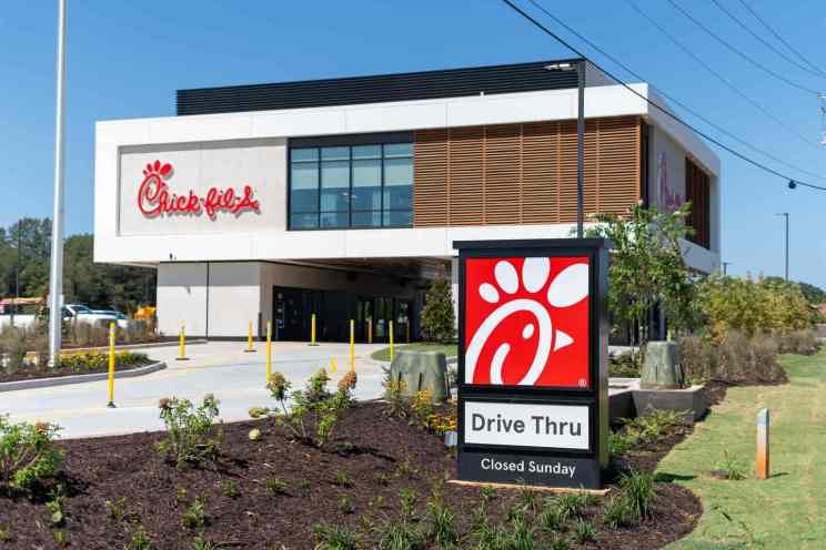 Outside view of four drive-thru lanes and an elevated kitchen with a meal transport system at Chick-fil-A.