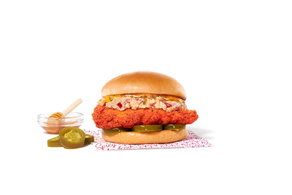 Honey Pepper Pimento Chicken Sandwich with honey and peppers on the side.