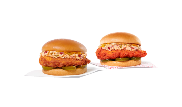 Two Honey Pepper Pimento Chicken Sandwiches on a serving board. One is spicy and one is original.