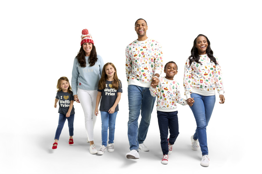 Smiling families in Chick-fil-A holiday-themed outfits, including “I Heart Waffle Fries” shirts and festive sweaters, walking together on a white background.