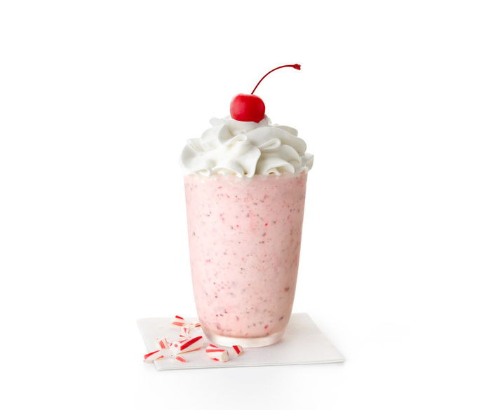 Broken candy canes next to a Peppermint shake.
