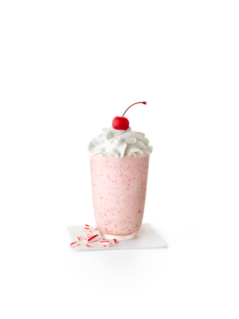 Broken candy canes next to a Peppermint shake