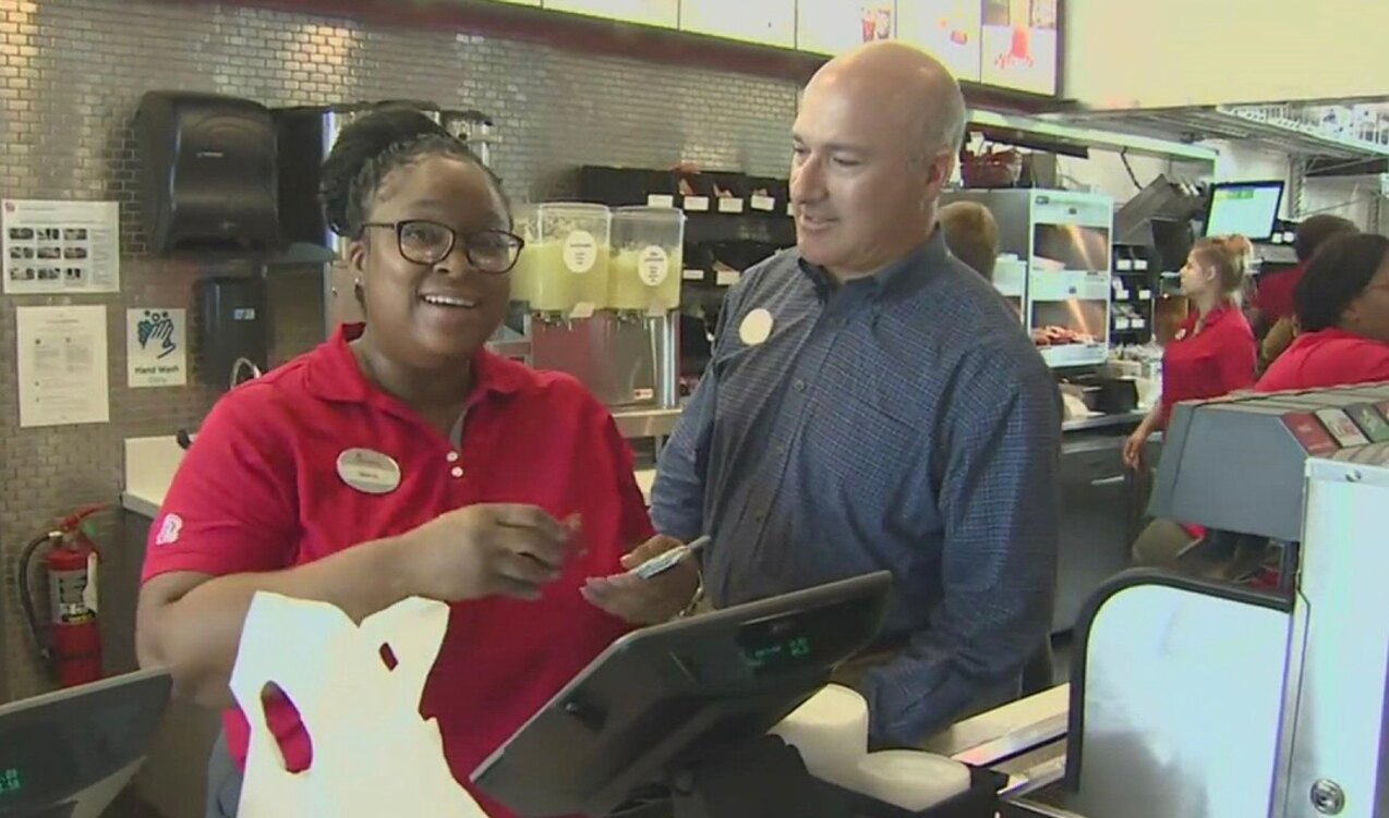 Tony and a team member talking while at the register in Chick-fil-A.