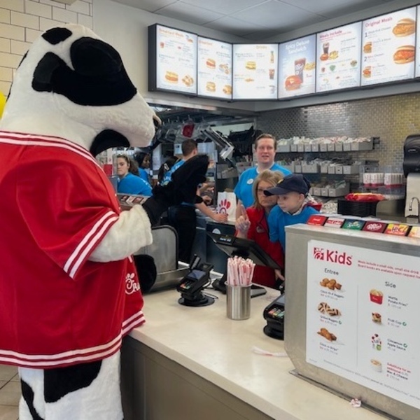 Chick-fil-A Cow Mascot at a Chick-fil-A counter