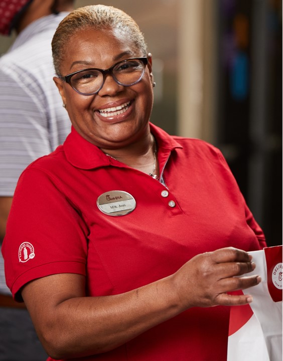 A Team Member holding a Chick-fil-A bag