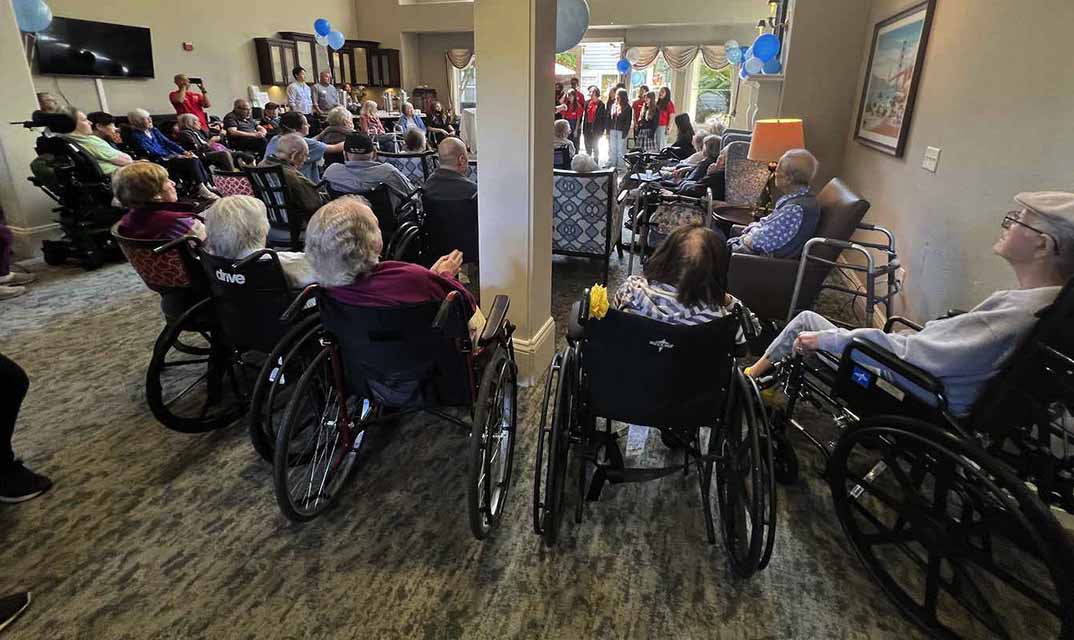 People at senior living facility Aegis Living San Francisco view presentation.