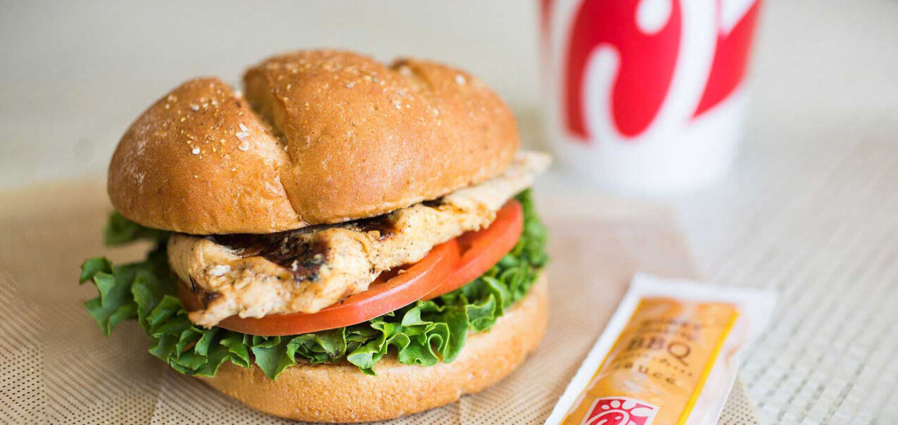 Grilled Chicken Sandwich with a packet of Honey Roasted BBQ next to it