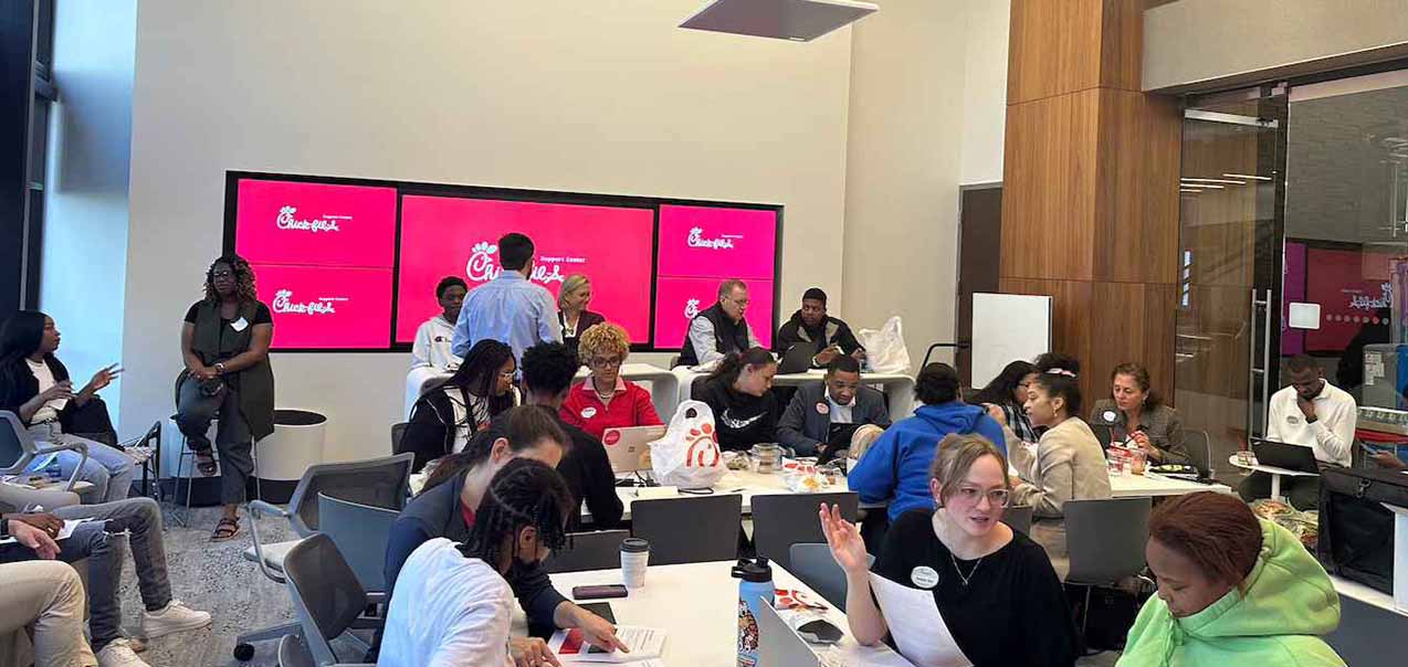 Students working with mentors at Beyond School Walls (BSW) program at the Chick-fil-A Support Center.