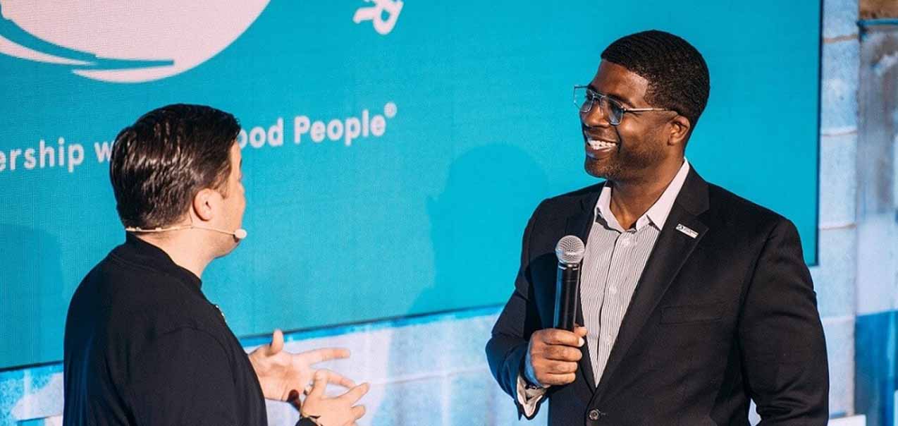 Two men talking on a stage.