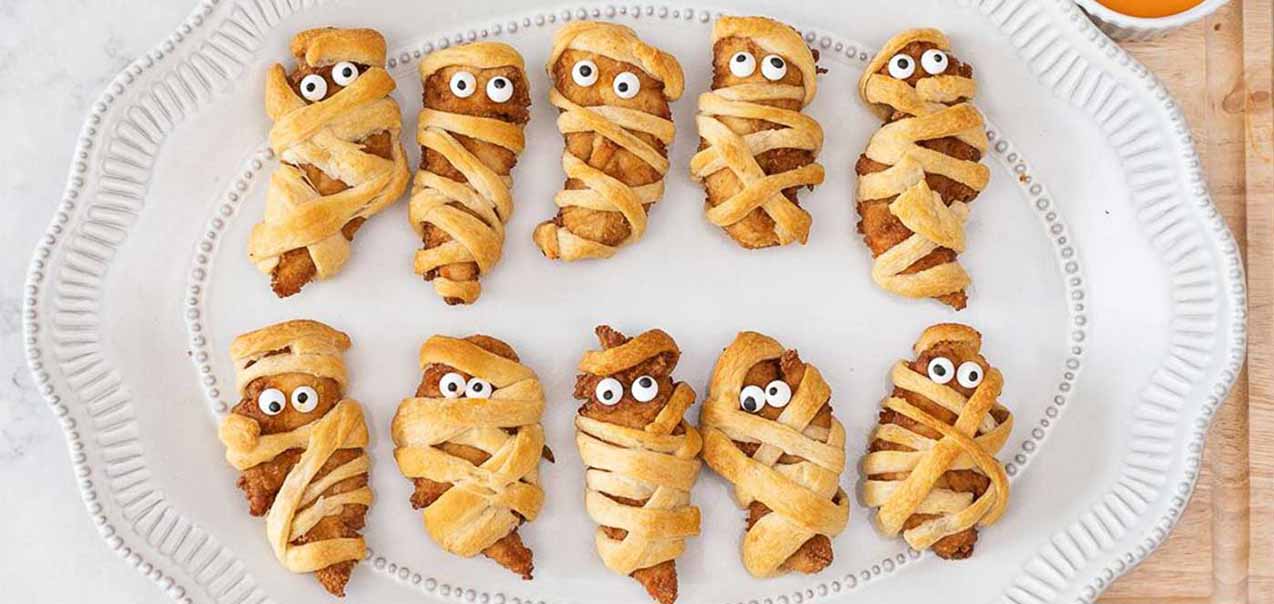 Chicken Strips wrapped in dough to look like mummies.