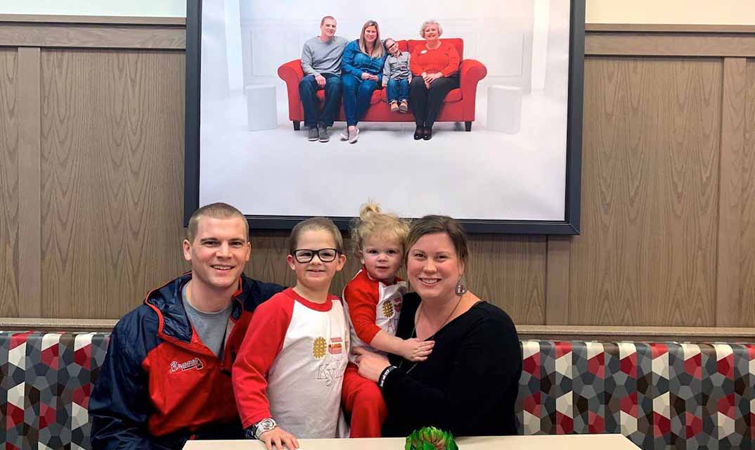 Family at a Chick-fil-A booth smiling