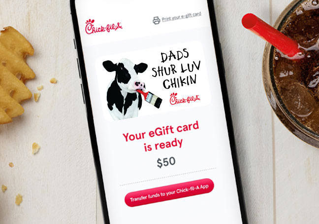 Smartphone displaying a Chick-fil-A eGift card with a cow illustration. 