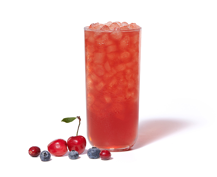 Cherry Berry Iced Tea on a white background with cherries, blueberries and cranberries