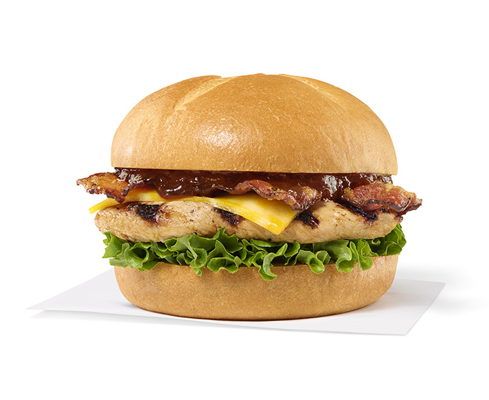 Grilled Smokehouse BBQ Bacon Sandwich with grilled chicken, bacon, cheese, lettuce, and barbecue sauce on a bun.