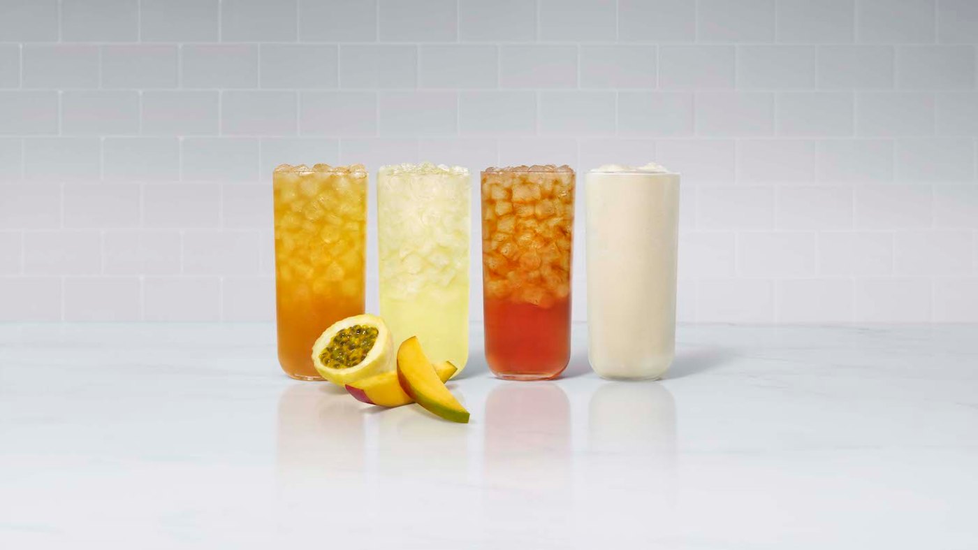 A glass of Mango Passion Sunjoy®, Mango Passion Lemonade, Mango Passion Tea and Mango Passion Frosted Lemonade, with fresh sliced mango and passion fruit.
