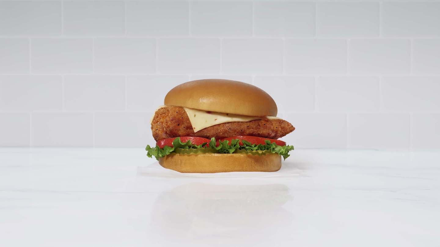 Spicy Deluxe Sandwich on white napkins