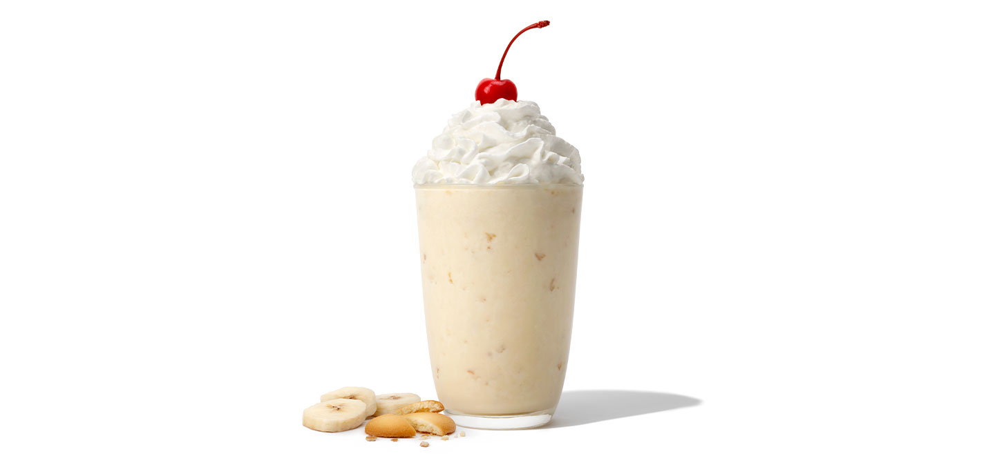 A Banana Pudding Milkshake with banana slices and wafers
