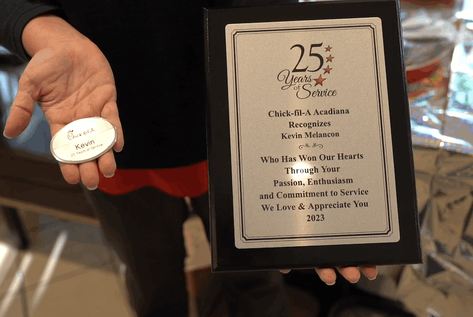 Team member holds 25 years of Service award.