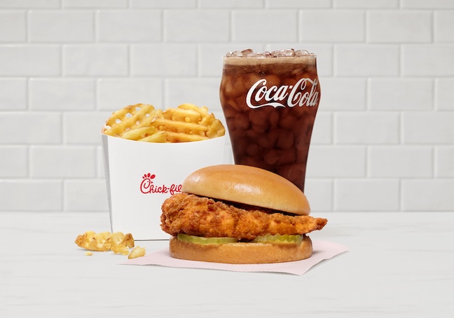 Original Chick-fil-A® Chicken Sandwich, Waffle fries in a branded fry box and a Coca-Cola in a glass
