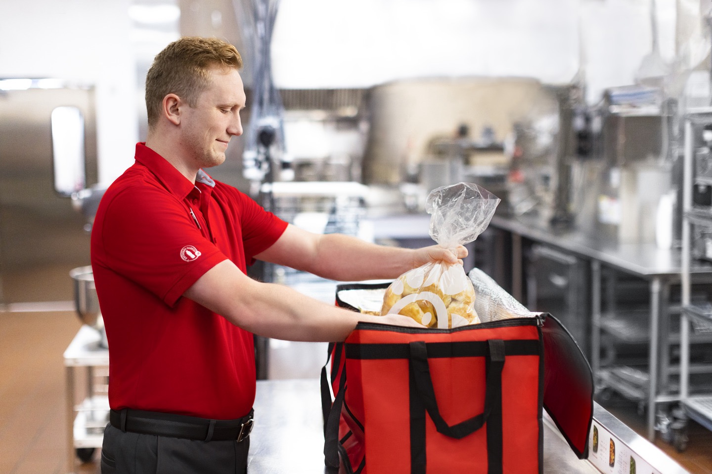 A Chick-fil-A Team Member packing a cooler with food.