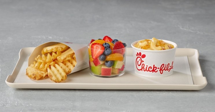 Chick-fil-A sides on a tray: Waffle fries, fruit salad, and macaroni and cheese.