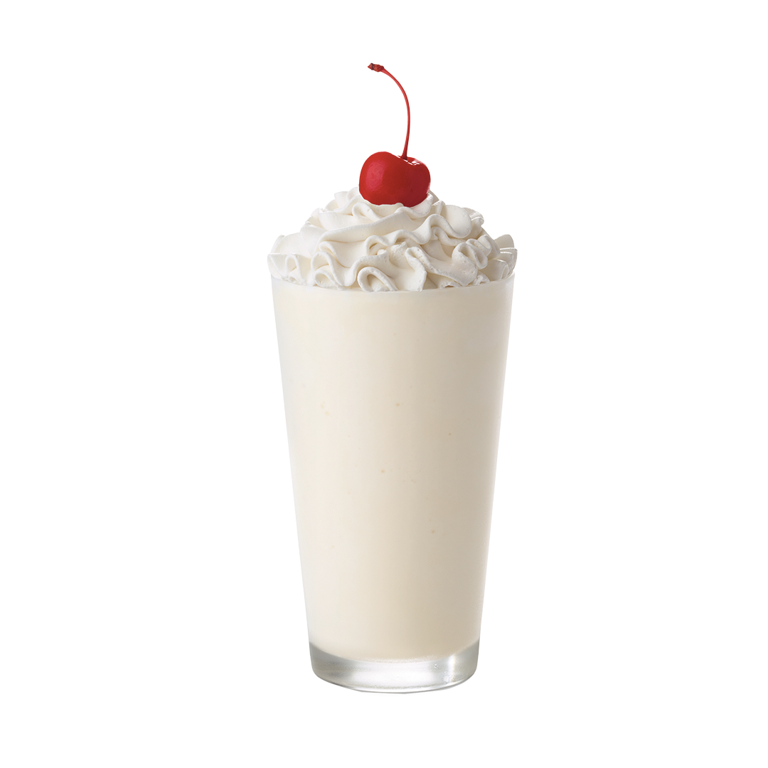 Vanilla milkshake in a glass topped with whipped cream and a cherry.
