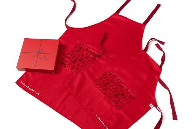 A red apron with a red gift box.