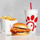 Chicken sandwich, waffle fries and a soft drink.