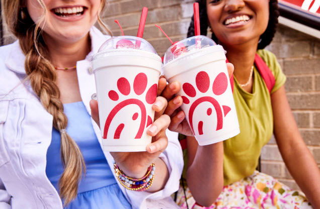 Two customers smiling holding shakes