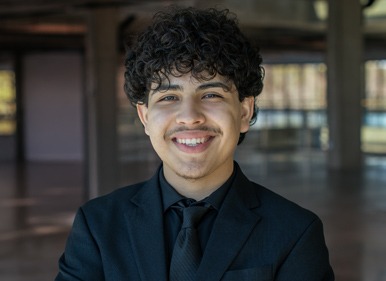 Headshot of Daniel with a blurred indoor background.