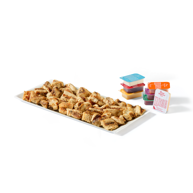 30-count Grilled Nuggets on a platter with stacked sauced options