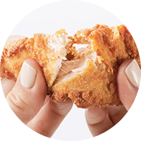 person breaking apart a Chick-fil-A Chick-n-Strip®