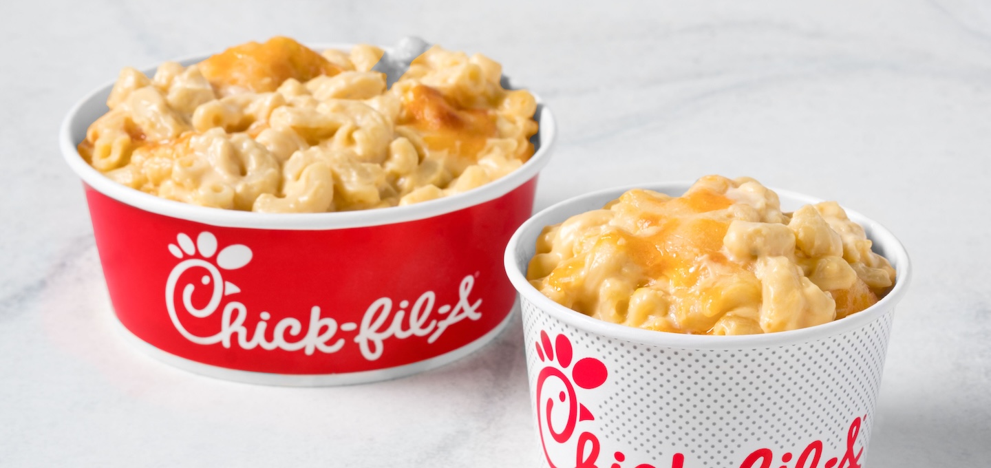 Mac & Cheese in a red branded bowl and Mac & Cheese in a white branded cup.