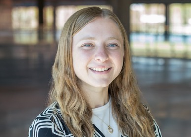 Headshot of Sammie with a blurred indoor background.