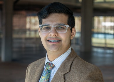 Headshot of Vick with a blurred indoor background.