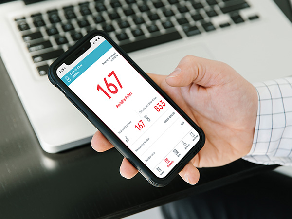 A person holding a smartphone displaying the Chick-fil-A app.