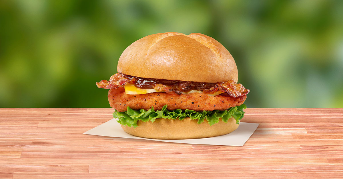 Spicy Smokehouse BBQ Bacon Sandwich with spicy chicken, bacon, cheese, lettuce, and barbecue sauce on a bun.