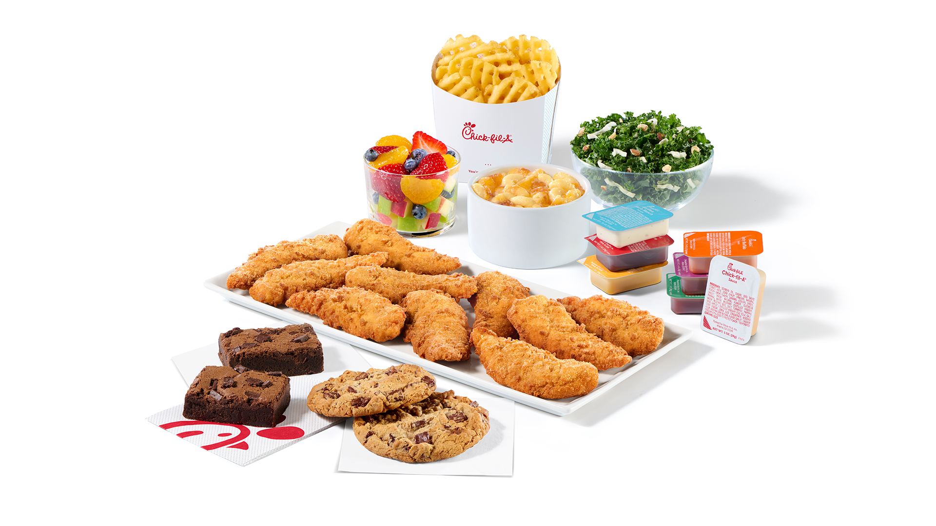 10 ct Chick-fil-A Chick-n-Strips®Family Style Meal with Waffle Fries, Kale Crunch Side, Fruit Cup, Mac & Cheese, stacks of Chick-fil-A sauces, two Chocolate Fudge Brownies and two Chocolate Chunk cookies