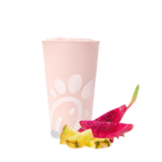 A glass of a Pineapple Dragonfruit Frosted Lemonade accompanied by slices of pineapple and dragon fruit.
