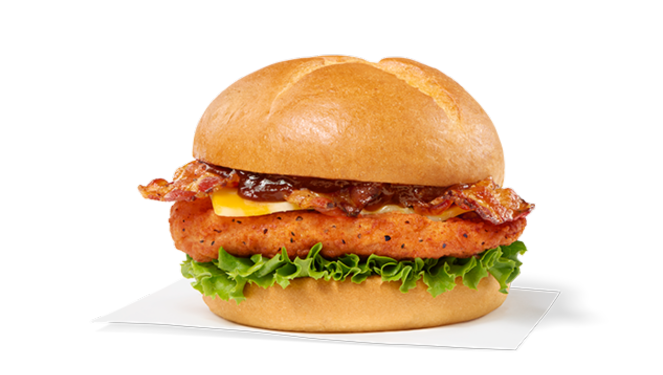 Spicy Smokehouse BBQ Bacon Sandwich with chicken, bacon, cheese, lettuce, and barbecue sauce on a bun.