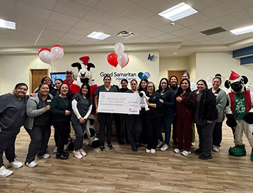 People from the Good Samaritan Health Centers of Gwinnett standing together smiling and holding a large check